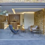 Thumbnail of http://Modern%20living%20space%20with%20brick%20walls,%20featuring%20a%20lounge%20area%20with%20two%20chairs,%20a%20coffee%20table,%20and%20a%20dining%20area%20with%20a%20wooden%20table%20and%20chairs.%20Glass%20doors%20open%20to%20the%20outside.