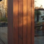 Thumbnail of http://With%20echoes%20of%20Grand%20Designs,%20this%20modern%20house%20showcases%20large%20glass%20windows%20that%20reflect%20the%20surrounding%20trees,%20revealing%20an%20inviting%20dining%20area%20inside.%20The%20space%20features%20several%20colorful%20chairs%20and%20a%20bar%20counter%20adorned%20with%20lush%20plants,%20embodying%20both%20style%20and%20nature.