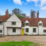 Thumbnail of http://Grade%20II%20listed%2015th%20Century%20historic%20home%20with%20white%20render,%20terracotta%20tile%20roof,%20multiple%20windows,%20and%20yellow%20entrance%20door%20set%20within%20gravel%20driveway%20and%20landscaped%20grounds.
