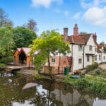 Thumbnail of http://Historic%2015th-century%20Grade%20II%20listed%20property%20with%20modern%20glazed%20extensions%20overlooking%20a%20river,%20featuring%20contemporary%20architectural%20integration.