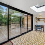 Thumbnail of http://Contemporary%20glass%20bifold%20doors%20opening%20onto%20decked%20terrace%20with%20countryside%20views%20in%20historic%20home%20renovation%20project.