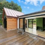 Thumbnail of http://Contemporary%20bifold%20doors%20and%20sliding%20glass%20systems%20integrated%20into%20a%20Grade%20II%20listed%2015th%20Century%20home%20renovation,%20featuring%20black%20framing%20and%20expansive%20glazing%20overlooking%20gardens.