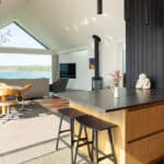 Thumbnail of http://Myrio%20Cornwall%20home%20with%20expansive%20bifold%20doors%20opening%20to%20coastal%20views,%20featuring%20kitchen%20island%20and%20living%20space%20with%20natural%20light.