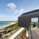 Thumbnail of http://Modern%20Cornish%20clifftop%20home%20at%20Sennen%20Cove%20with%20expansive%20bifold%20doors%20opening%20onto%20terrace%20overlooking%20turquoise%20waters%20and%20sandy%20beach%20below.