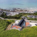 Thumbnail of http://Myrio%20Cornish%20home%20with%20bifold%20doors%20opening%20onto%20coastal%20views,%20featuring%20modern%20architecture%20integrated%20into%20clifftop%20landscape%20above%20Sennen%20Cove.
