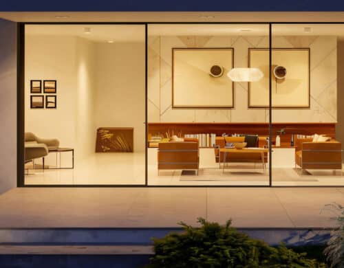 SF80 high performance sliding doors with triple glazed panels illuminated at night, showcasing modern minimalist interior with wooden cabinetry and warm ambient lighting.
